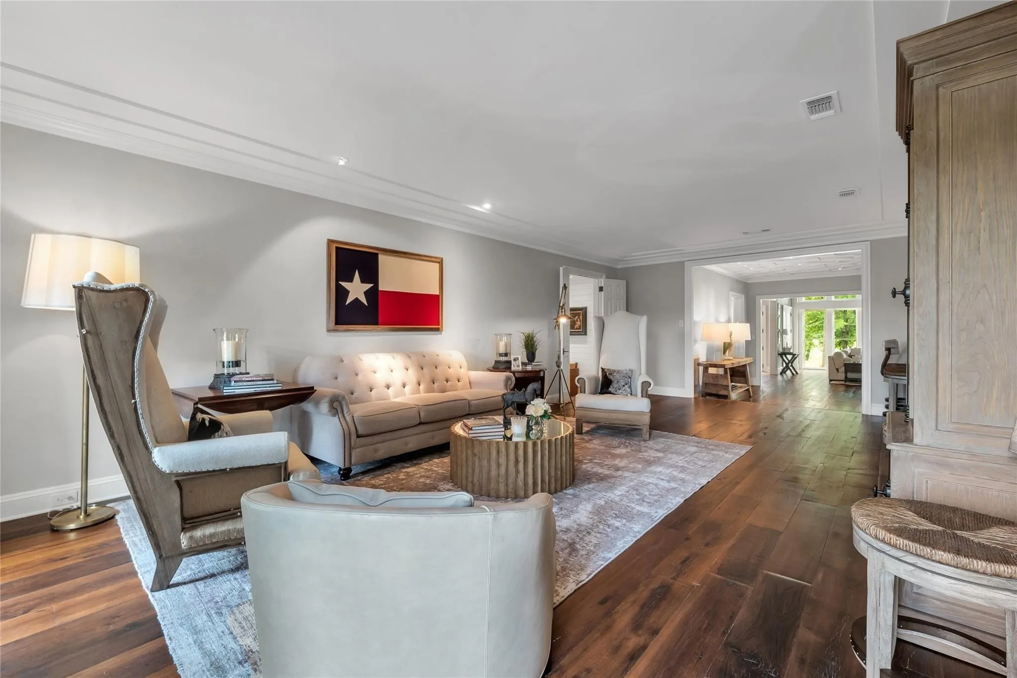 Hardwood flooring, recessed lighting, crown molding, cased openings, and light wall finishes