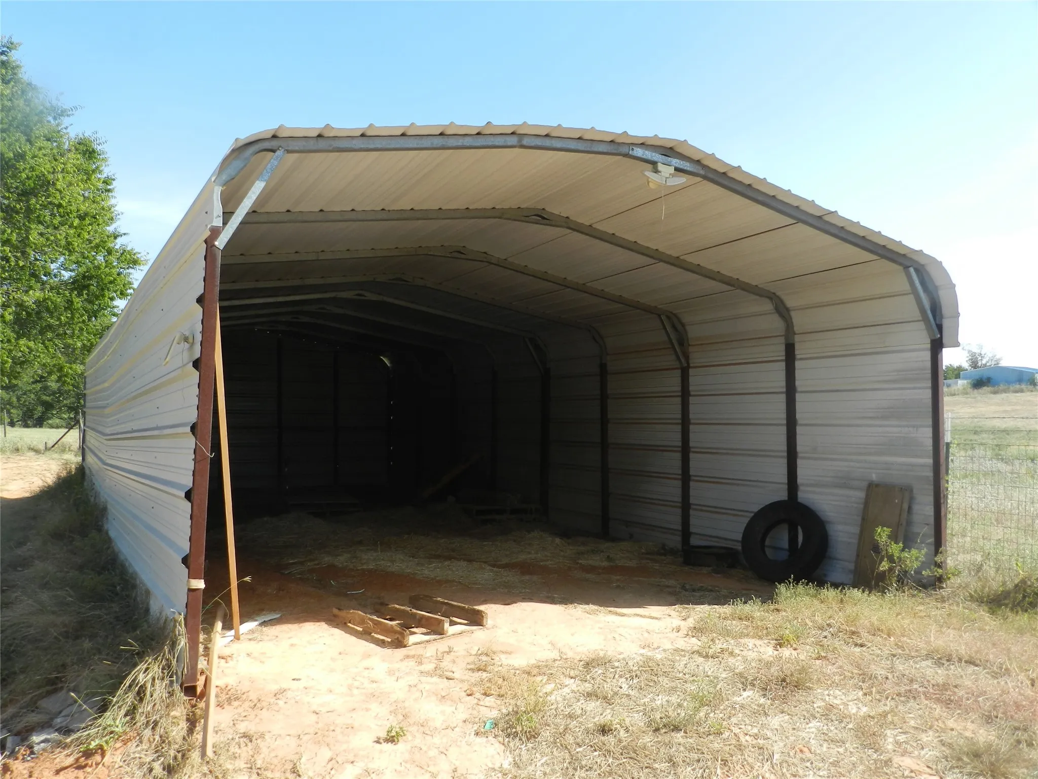 Metal-sided utility structure with an arched roof