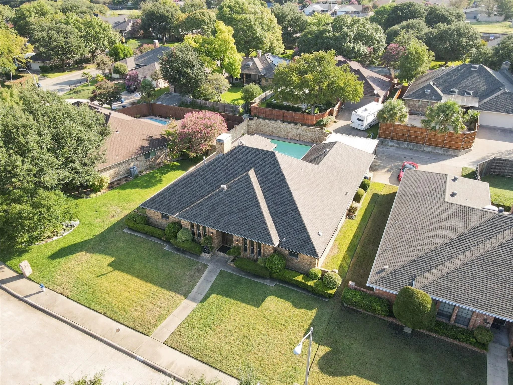 Exterior brick facade, concrete walk, and mature landscaping