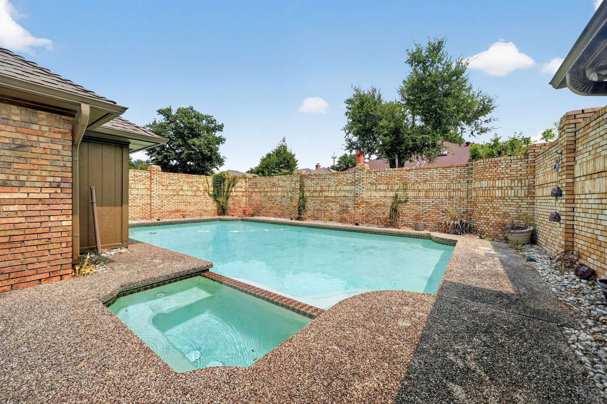 Outdoor pool and spa with textured coping