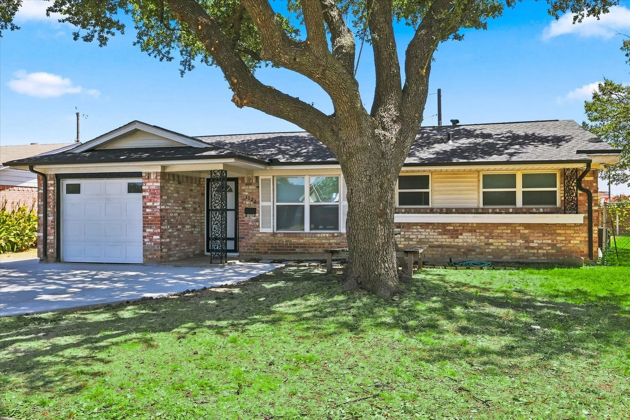 Brick exterior with a gabled roof and attached garage