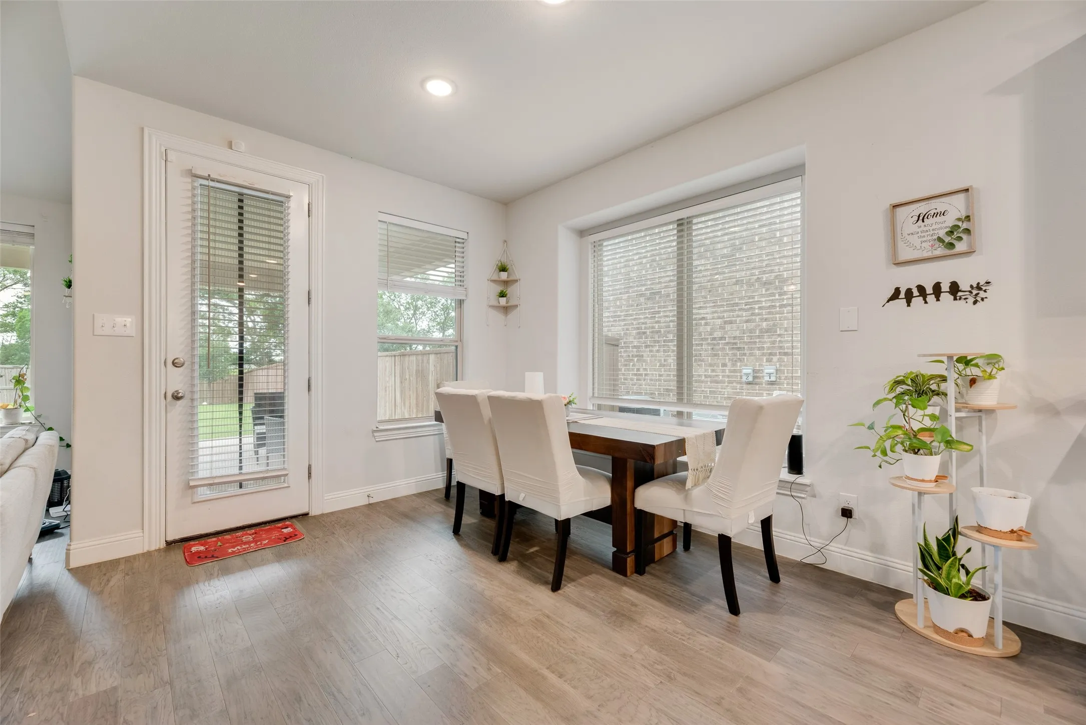 Dining space with a healthy amount of sunlight, baseboards, and wood finished floors