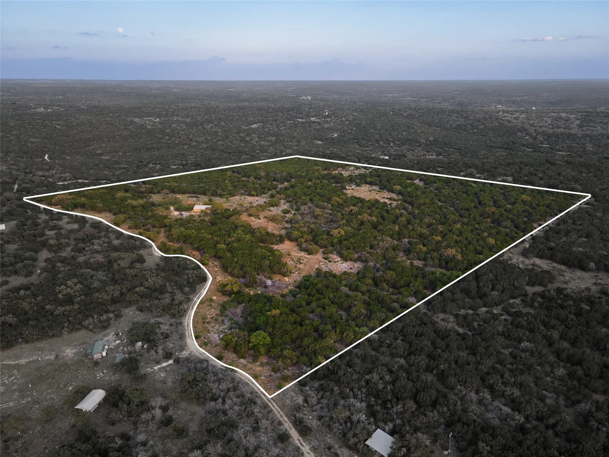 Expansive land parcel featuring dense tree coverage and varied terrain