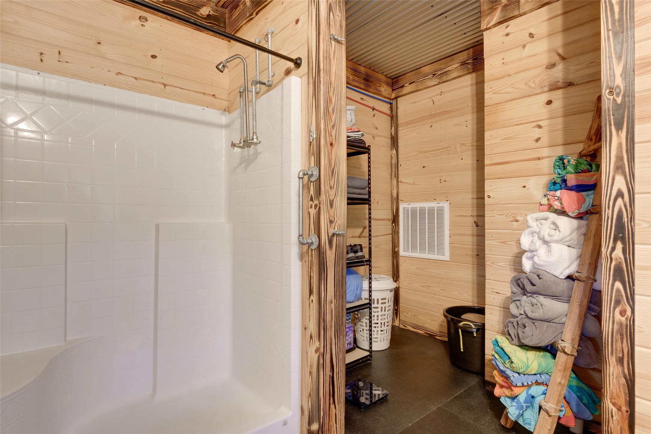 Walk-in shower with a multi-function showerhead and integrated seating