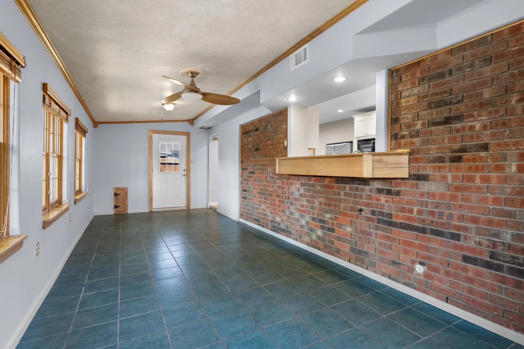 Sunroom continued — brick pass-through opens to the kitchen, perfect for entertaining