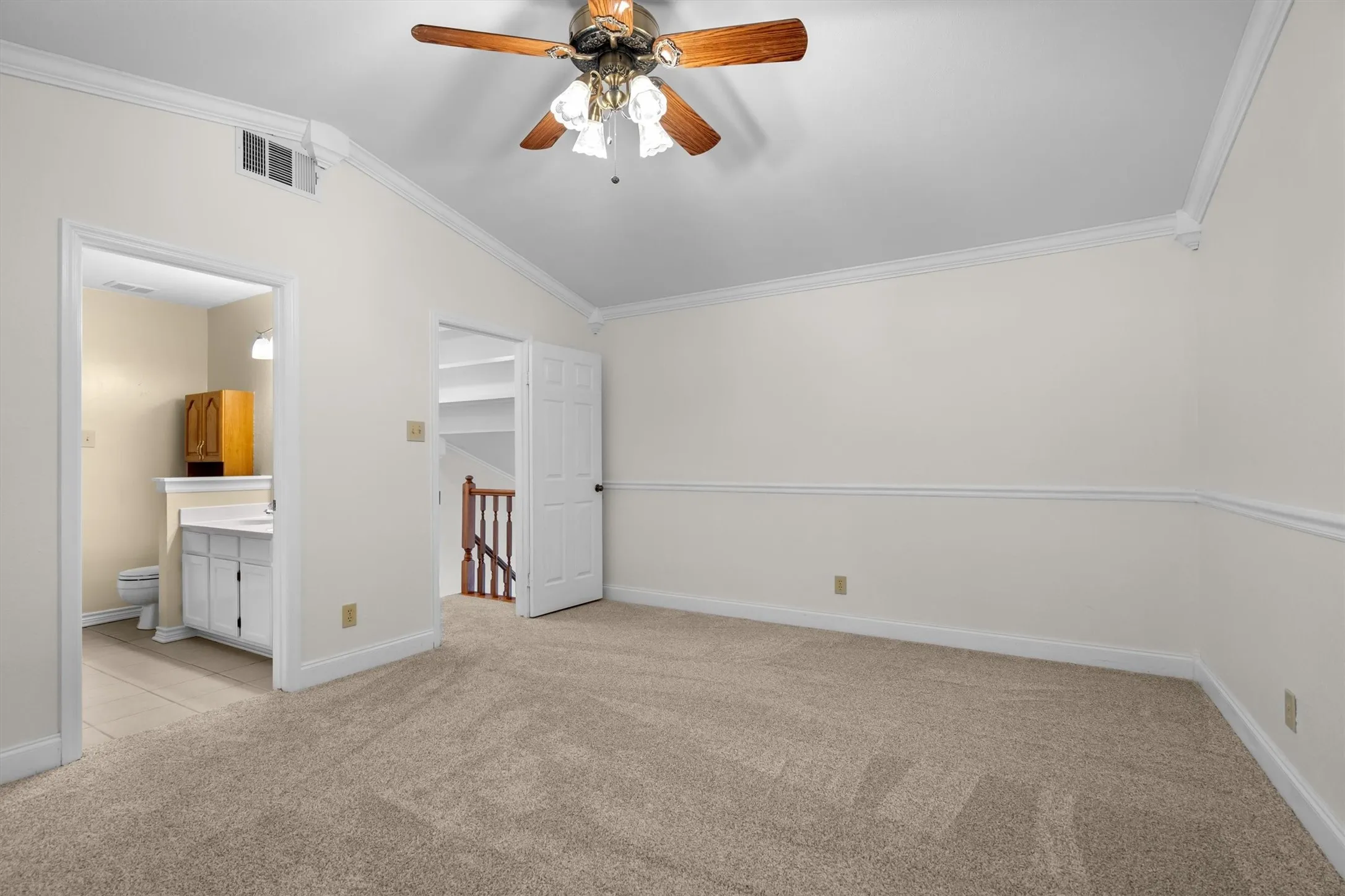 Bedroom with private ensuite bath access and ceiling fan
