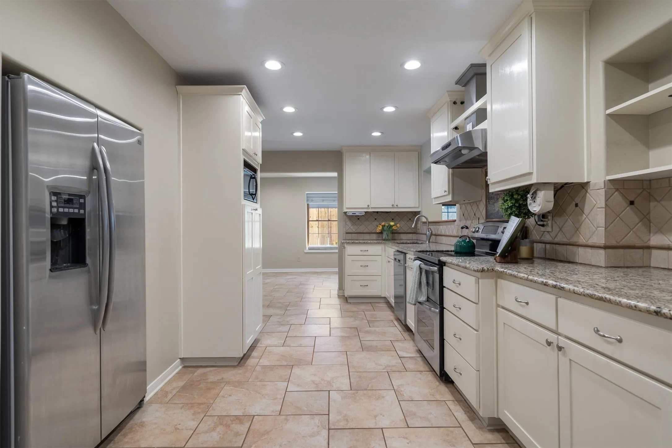 Gourmet kitchen with stainless steel appliances flowing seamlessly into the living space