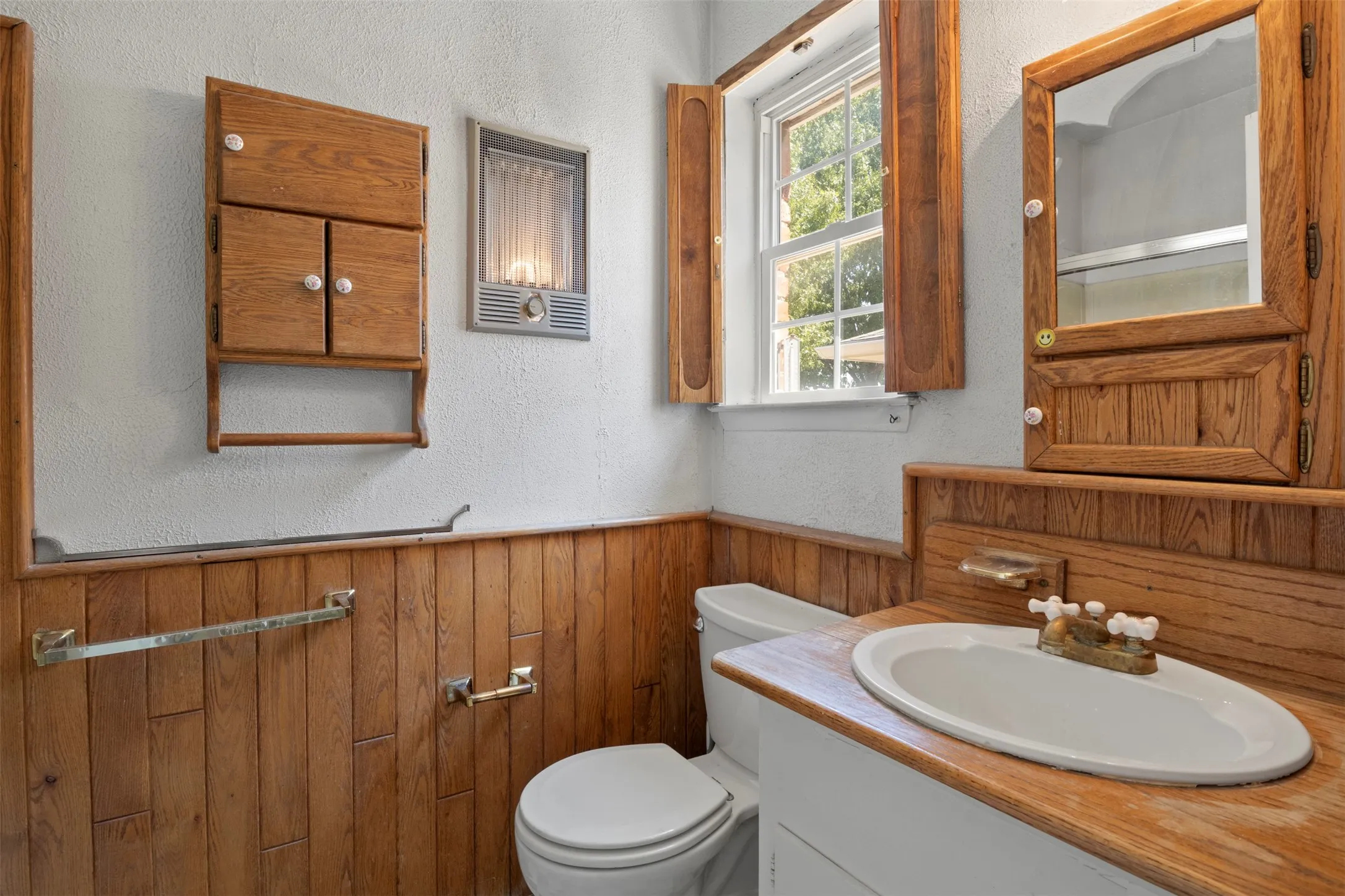 Wood-paneled wainscoting and coordinating wood-finish cabinetry
