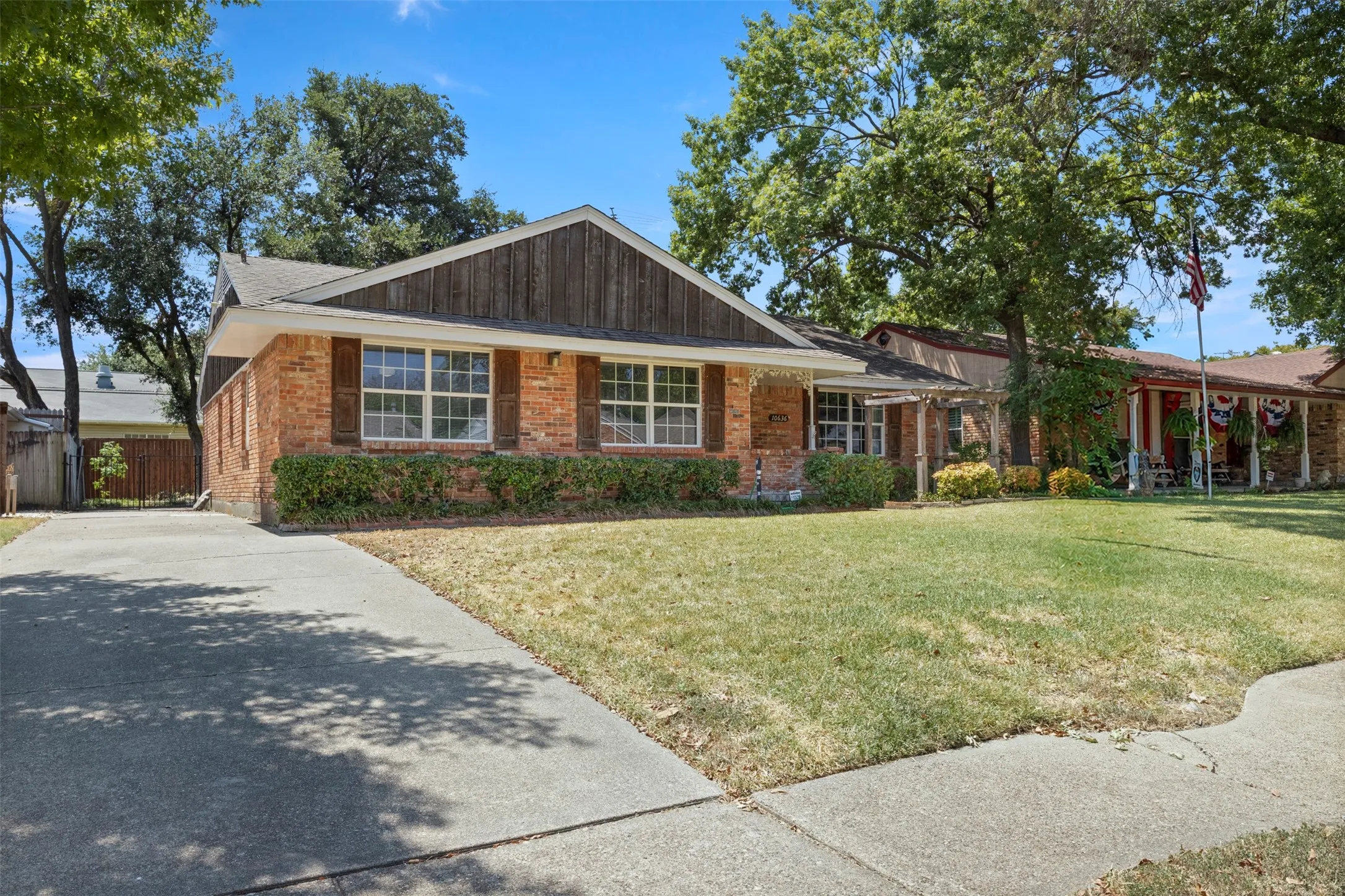 Brick exterior with a gabled roofline and board and batten siding