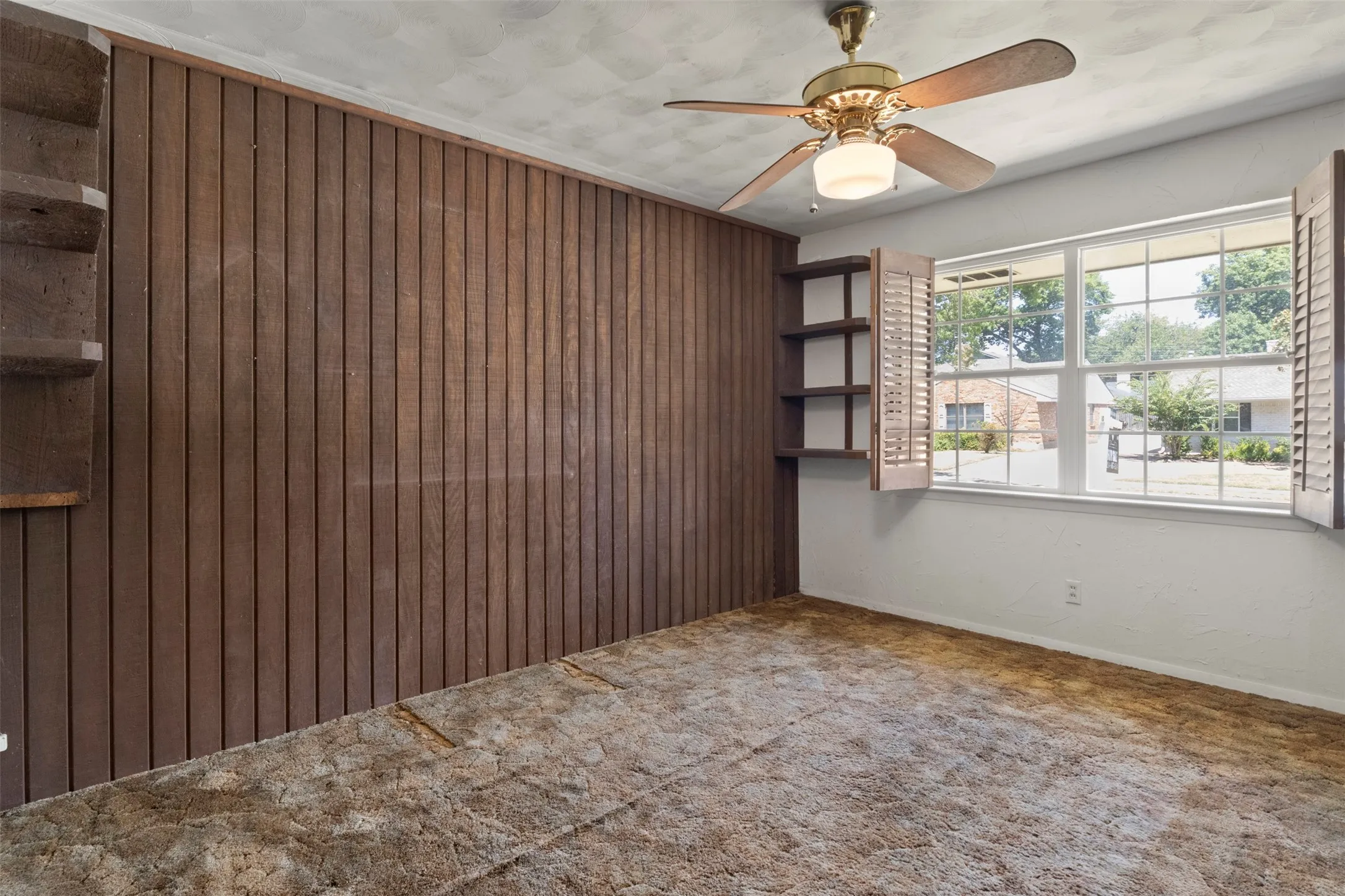 Wood-paneled wall with built-in shelving