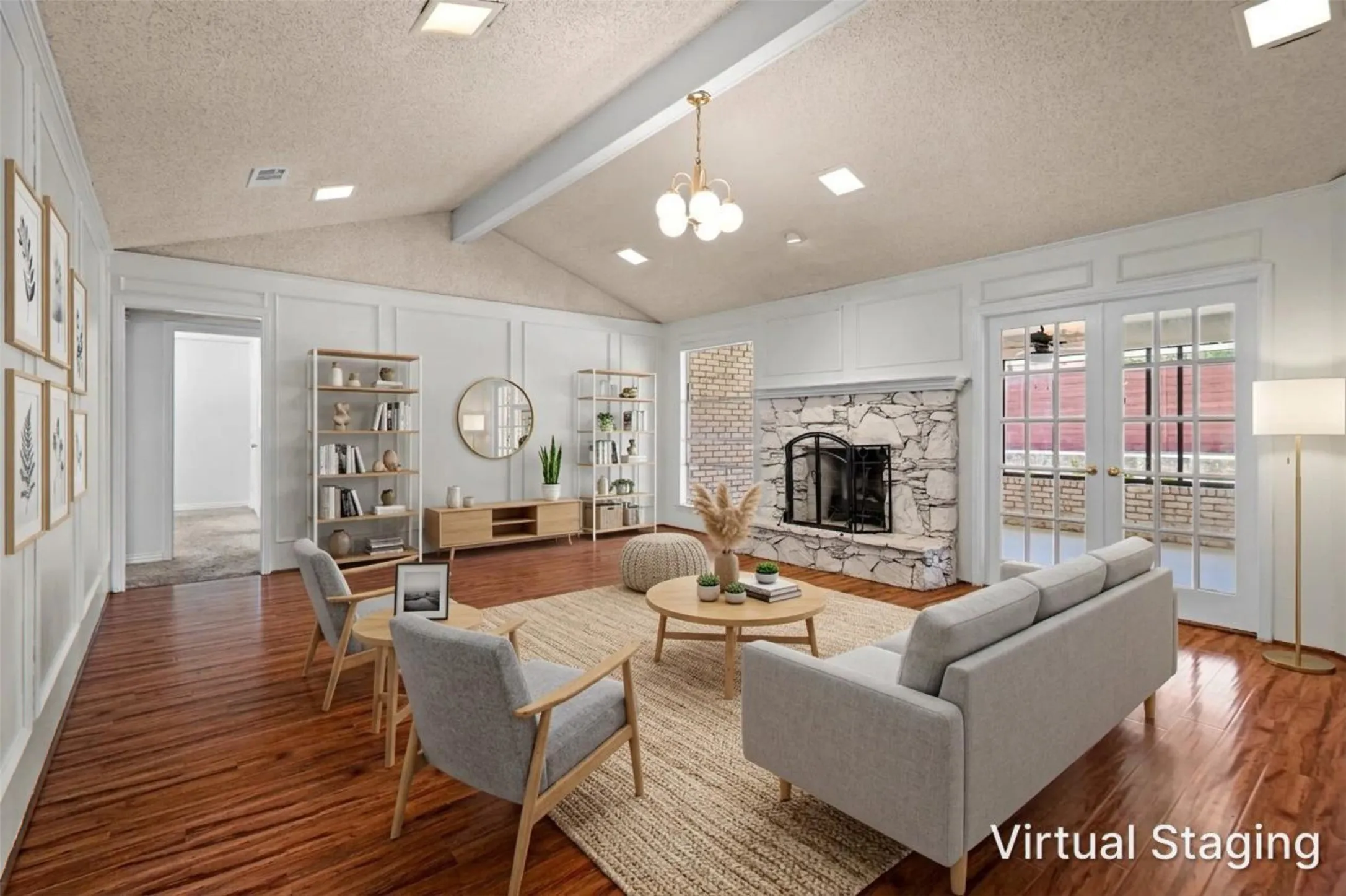 Vaulted ceilings with exposed beam, stone-surround fireplace with hearth, wood-finish flooring, paneled wall detailing, and double French doors