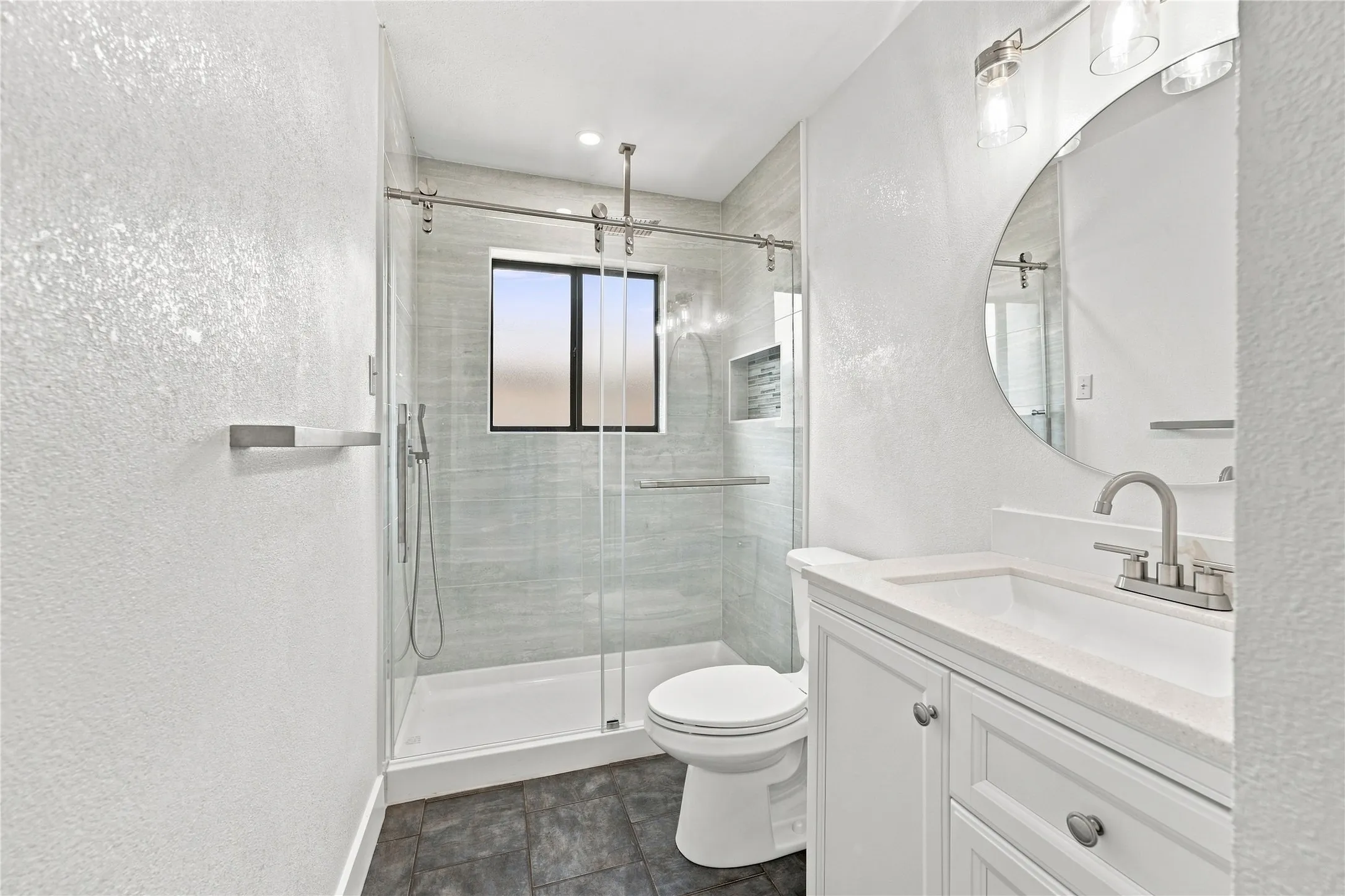 Beautifully remodeled bathroom featuring luxury finishes and a rainfall shower for a sleek, spa-inspired feel.
