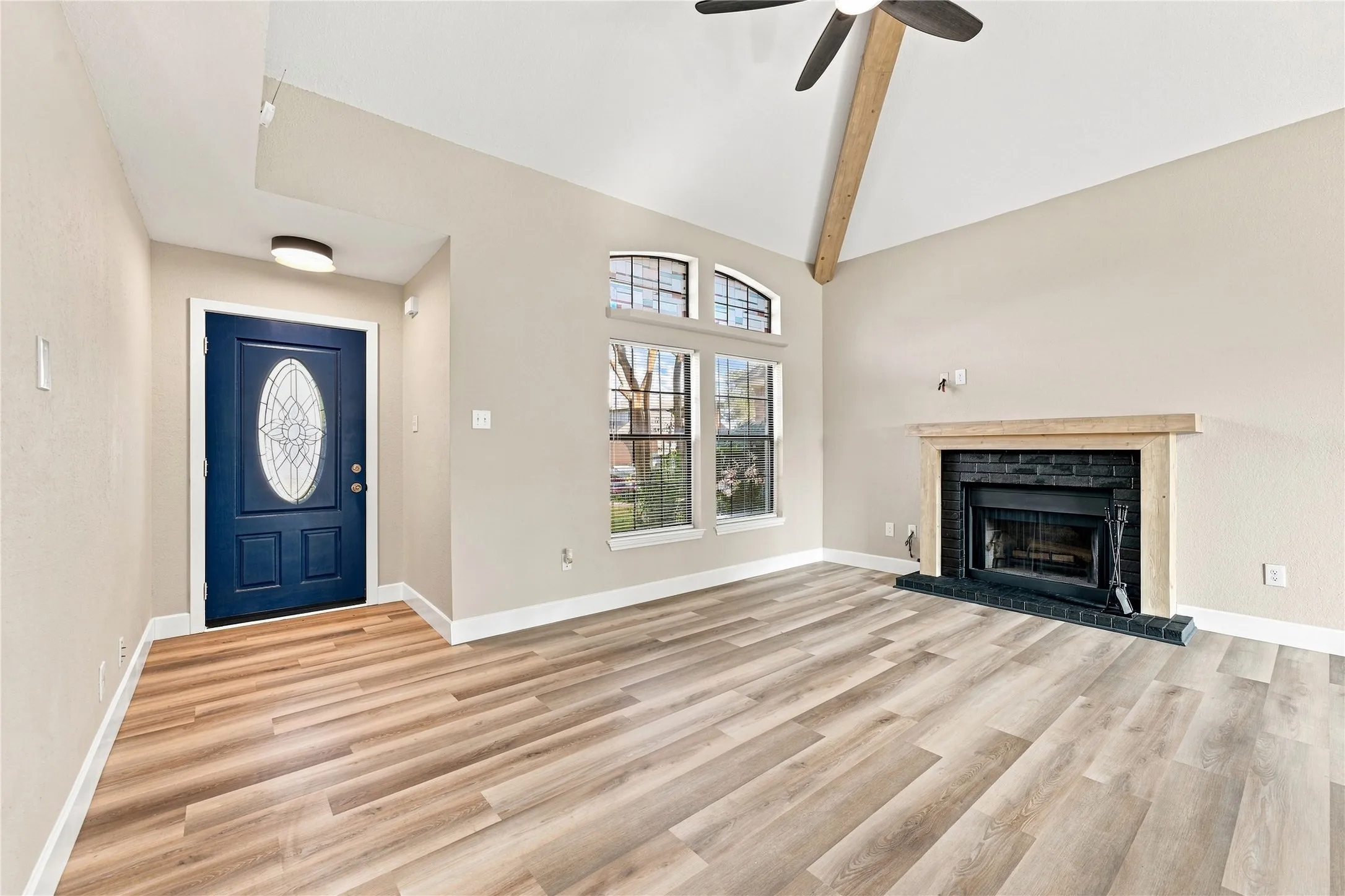 Welcoming entryway flowing seamlessly into the spacious living room, creating a bright and inviting first impression.