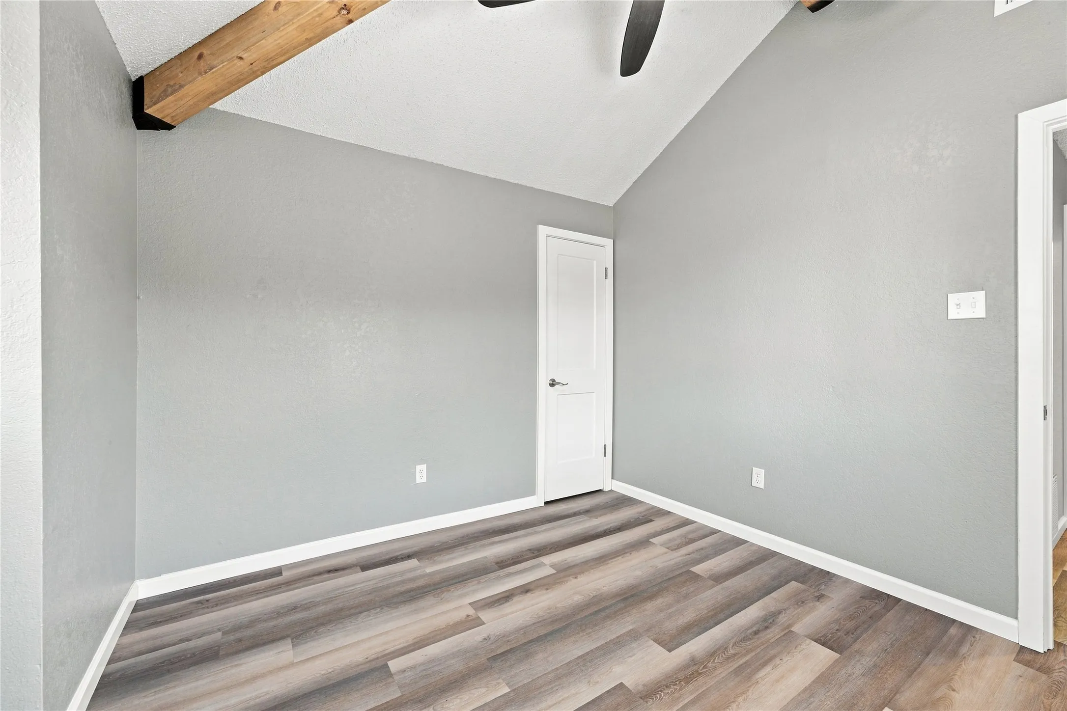 Inviting upstairs bedroom highlighted by vaulted ceilings and an open, elevated feel.
