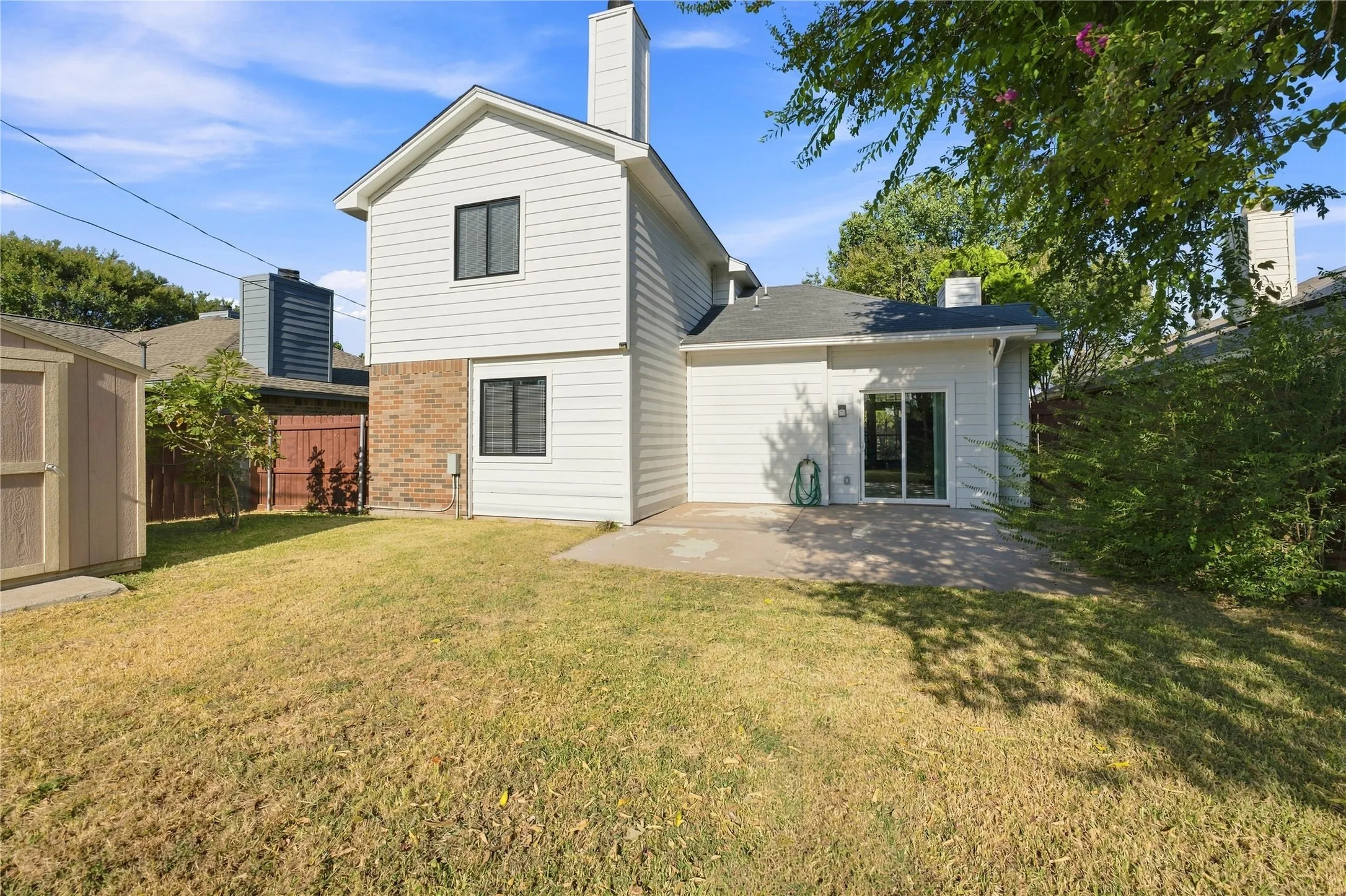 Rear exterior of the home showcasing the spacious backyard and outdoor layout.