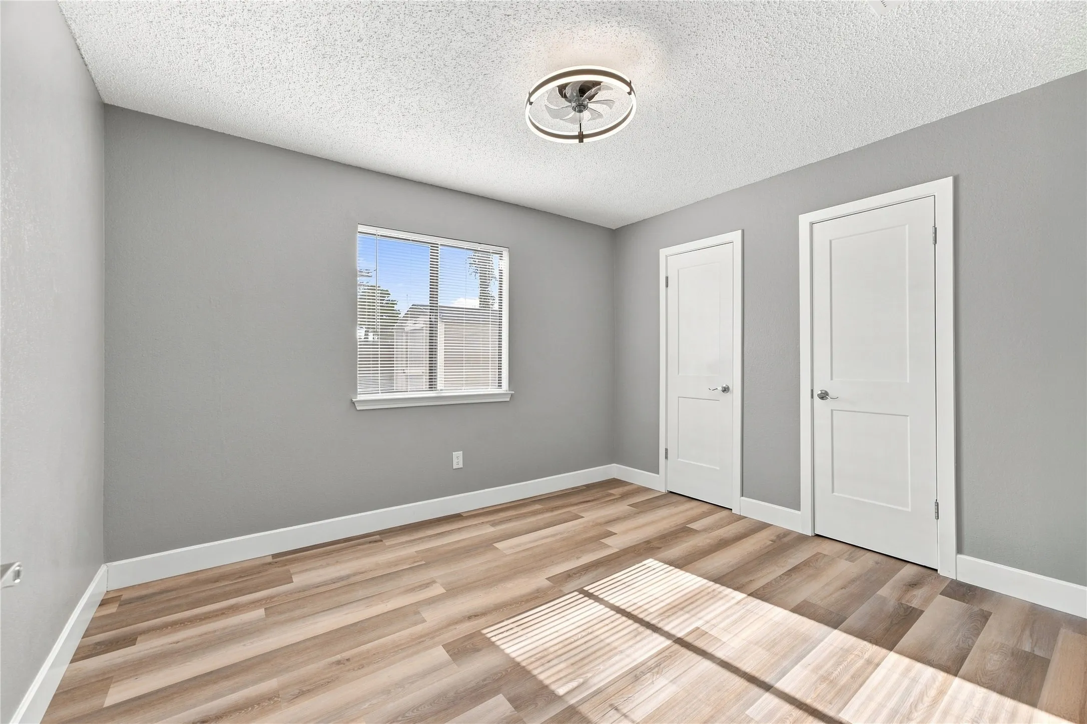Spacious bedroom featuring dual closets, offering excellent storage and everyday functionality.