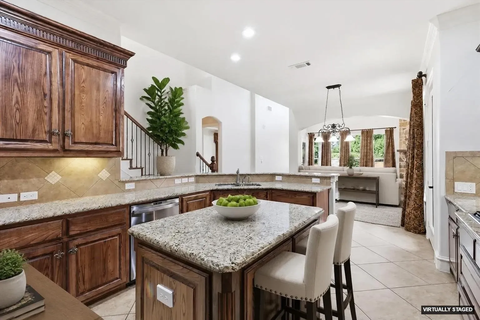 Kitchen featuring wood cabinetry, granite countertops, tile flooring, and stainless steel appliances