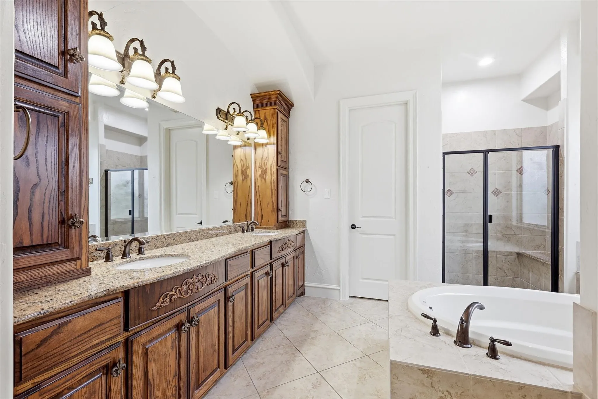 Dual sink vanity with wood-finish cabinetry and granite-style countertop