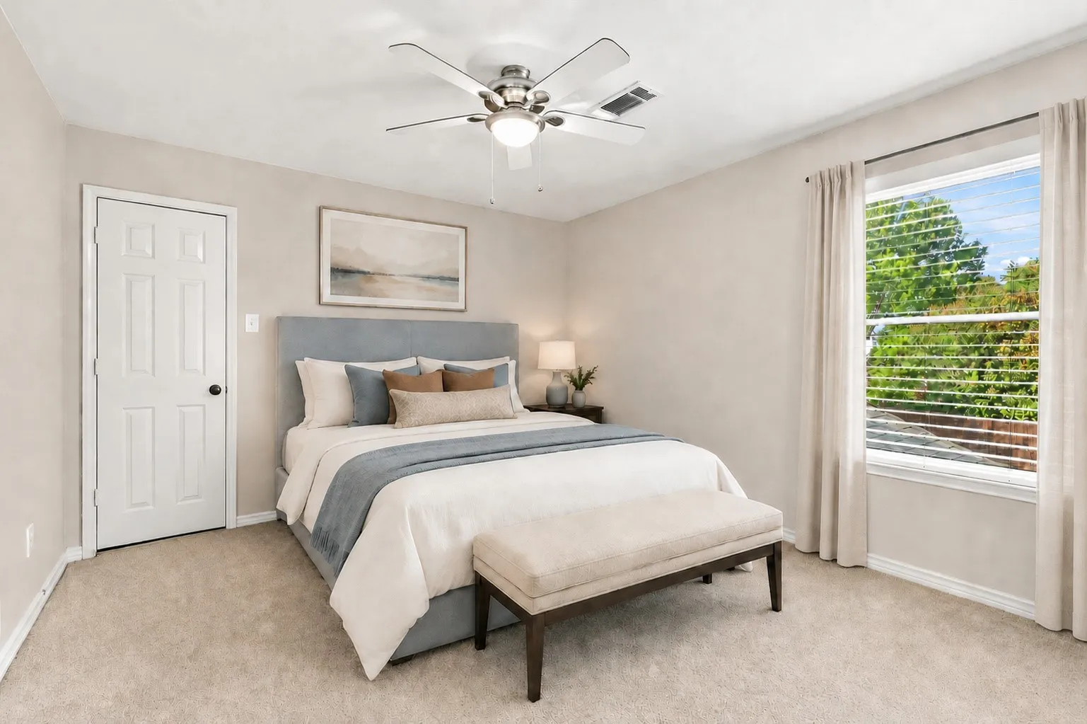 Virtually Staged Neutral tone wall paint, light-colored carpet flooring, recessed window with horizontal blinds, ceiling fan with light fixture, and a paneled door with dark hardware