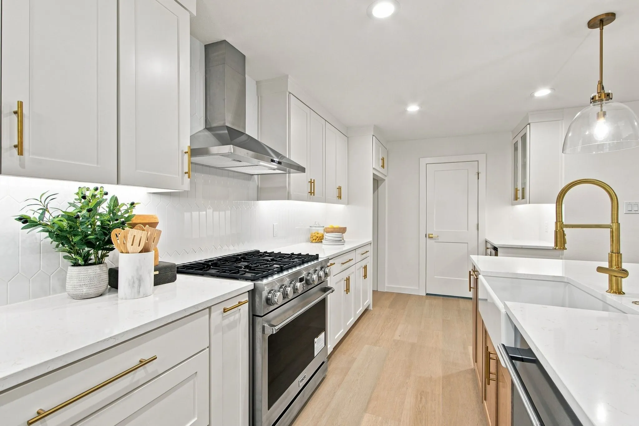 Amazing kitchen with SS 6 burner gas cooktop range with appliance drawer and spice rack on either side and stainless vent-a-hood!
