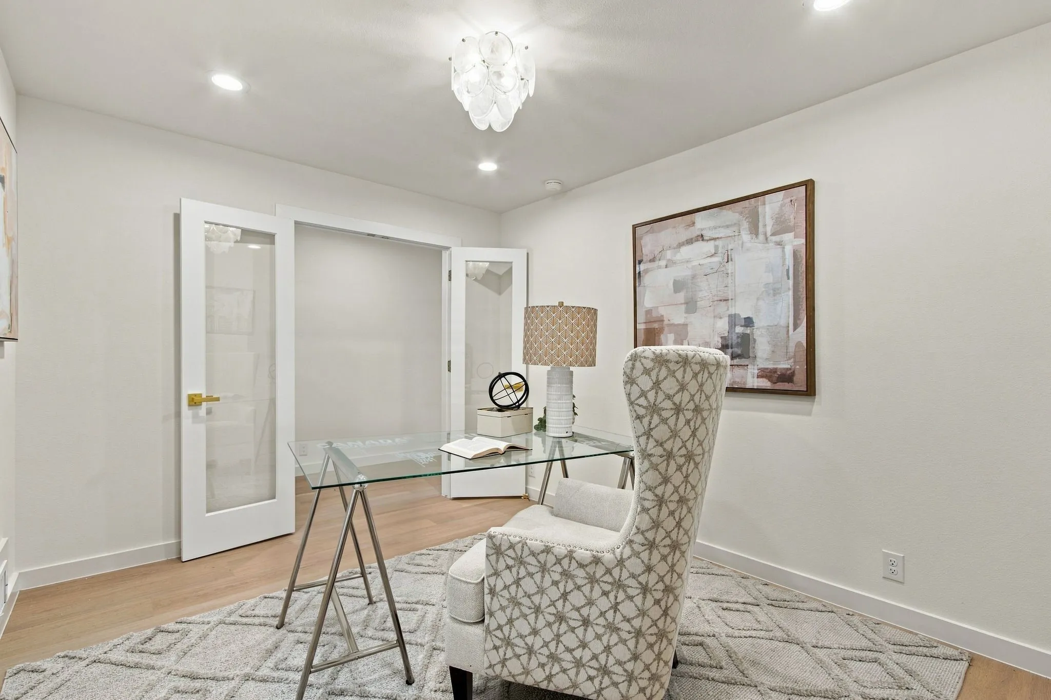 Recessed lighting, wood-finish flooring, and white walls