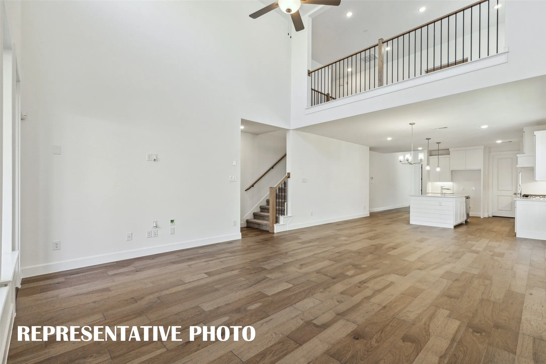 The game room features open railing overlooking the family room creating a multi-level entertaining space!  REPRESENTATIVE PHOTO