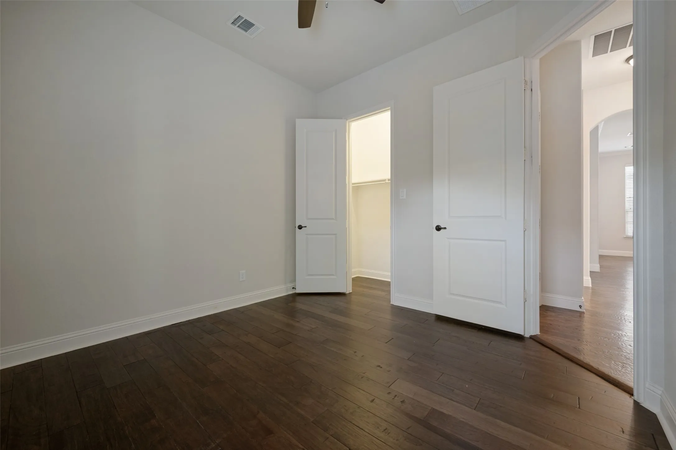 Dark wood-finish flooring complements light-toned walls