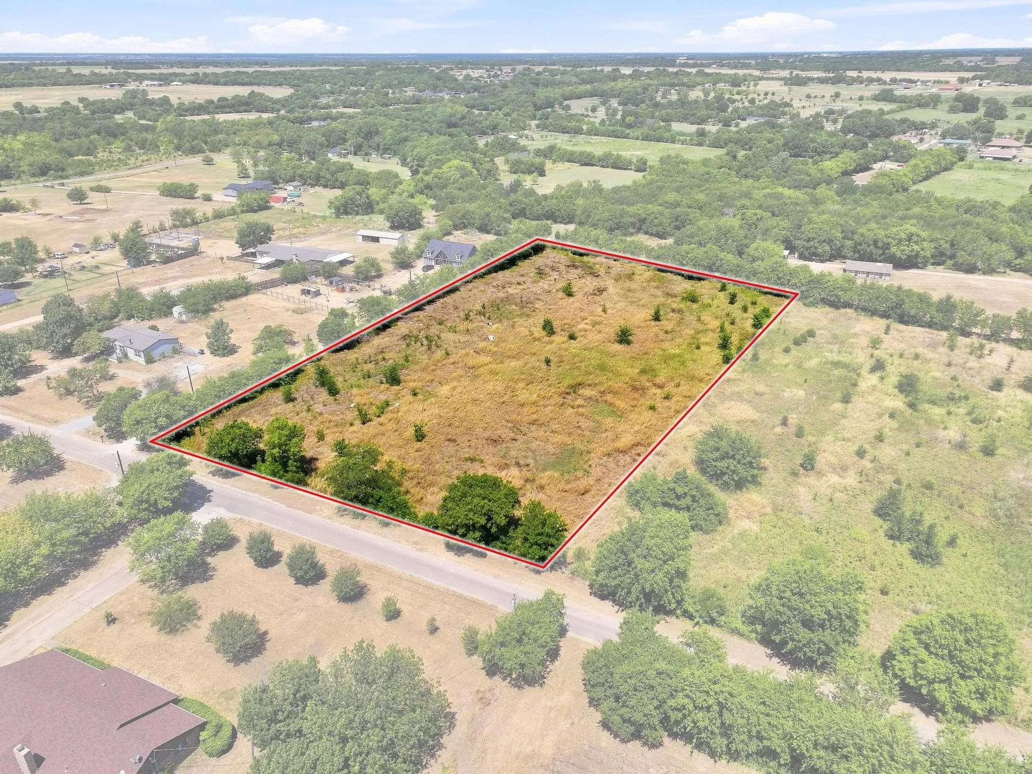 Expansive land parcel featuring natural terrain and mature trees