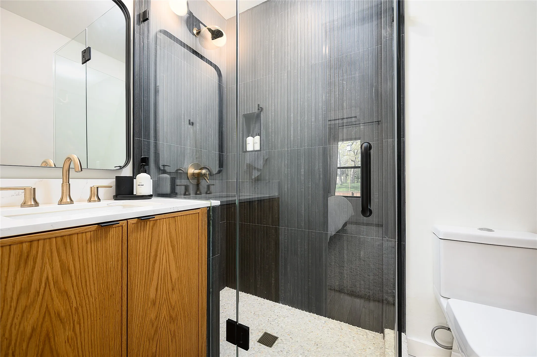 Primary en-suite with walk-in shower, high-end finishes