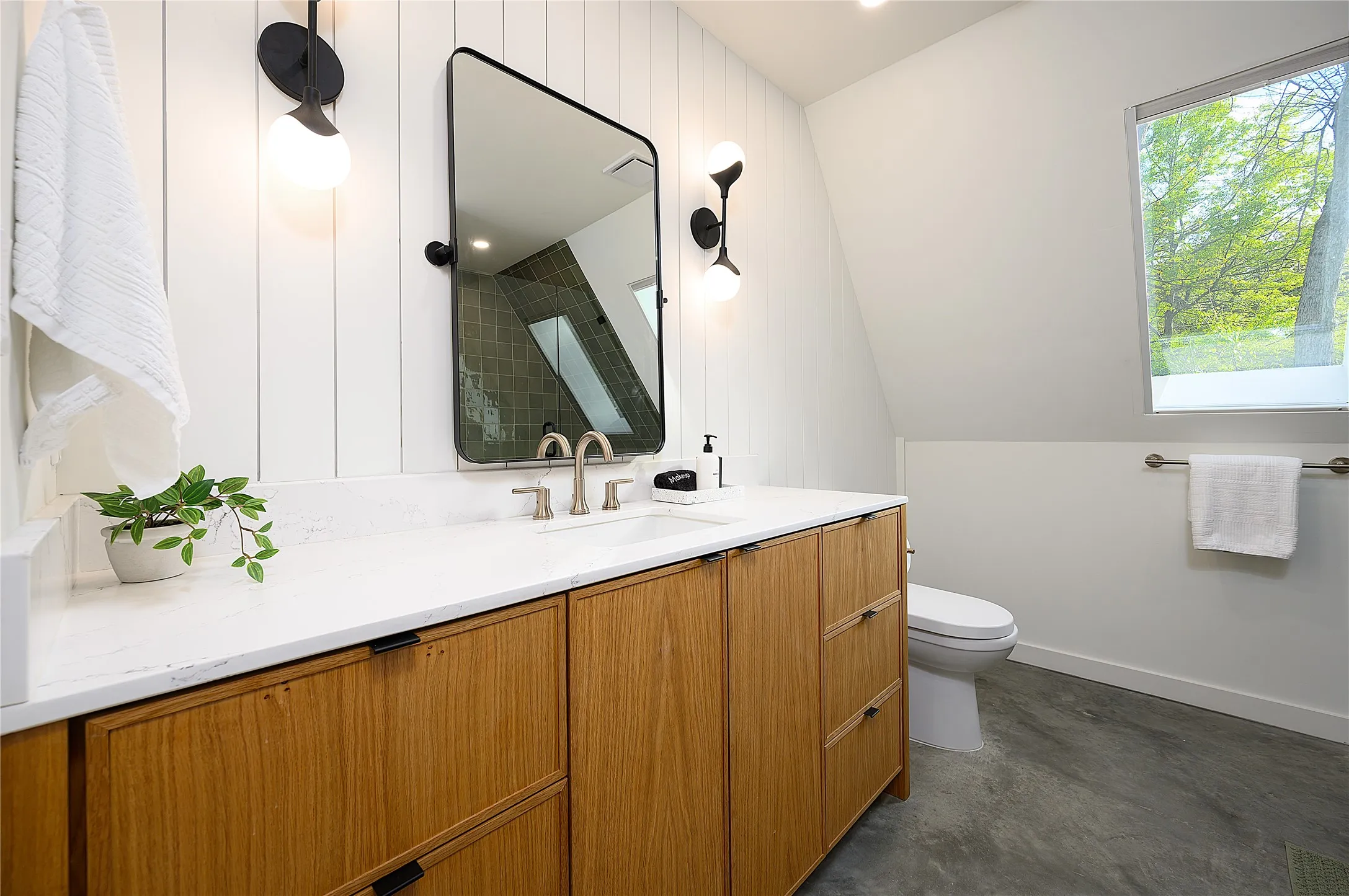Main floor bathroom with lots of storage and natural lighting