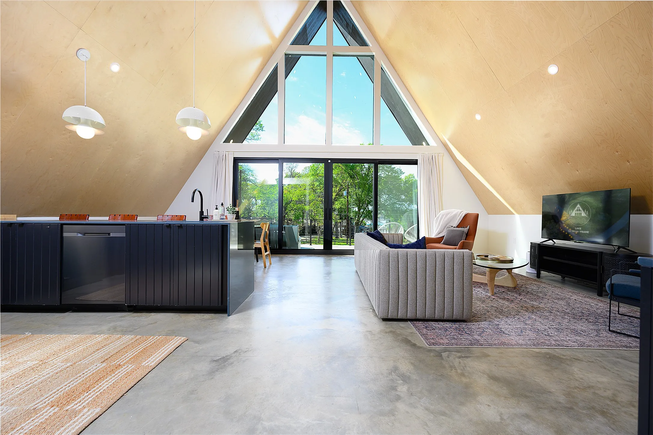 Waterfall counter top, built-in bar, low-maintenance sealed concrete floors.