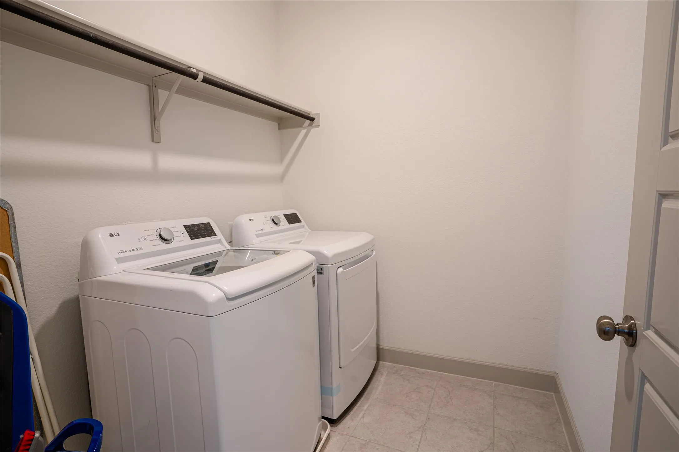 Utility area with shelving and tile flooring