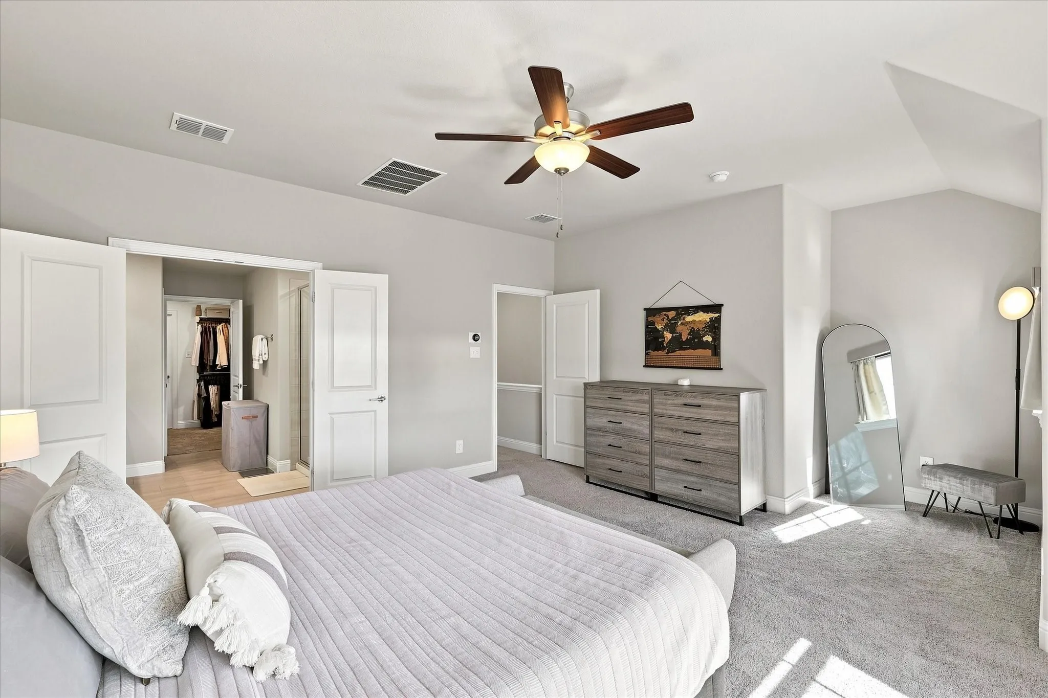 Wood-finish ceiling fan, recessed lighting, carpeted flooring, and a flat-panel door