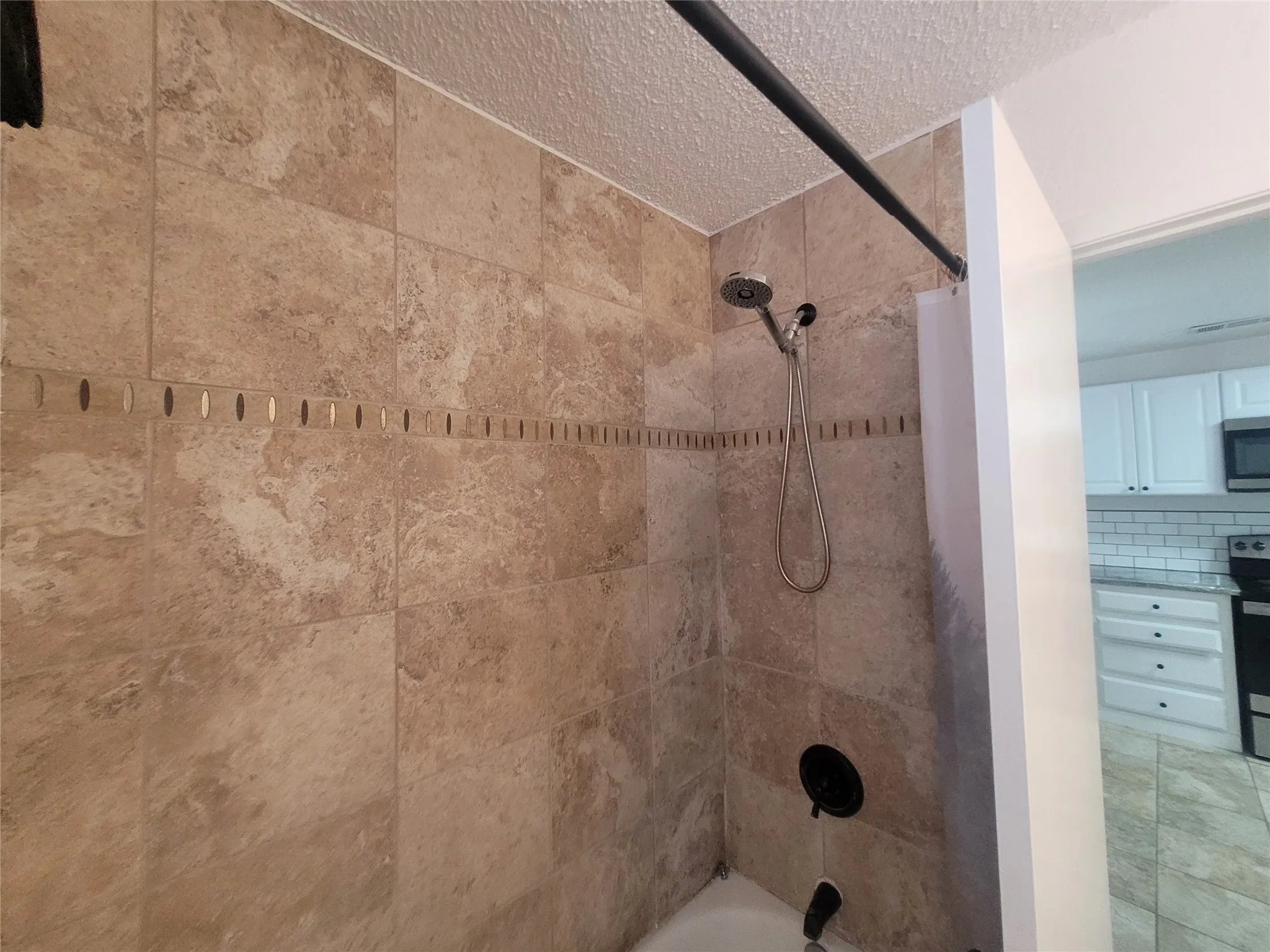 Tile surround in tub and shower combination.