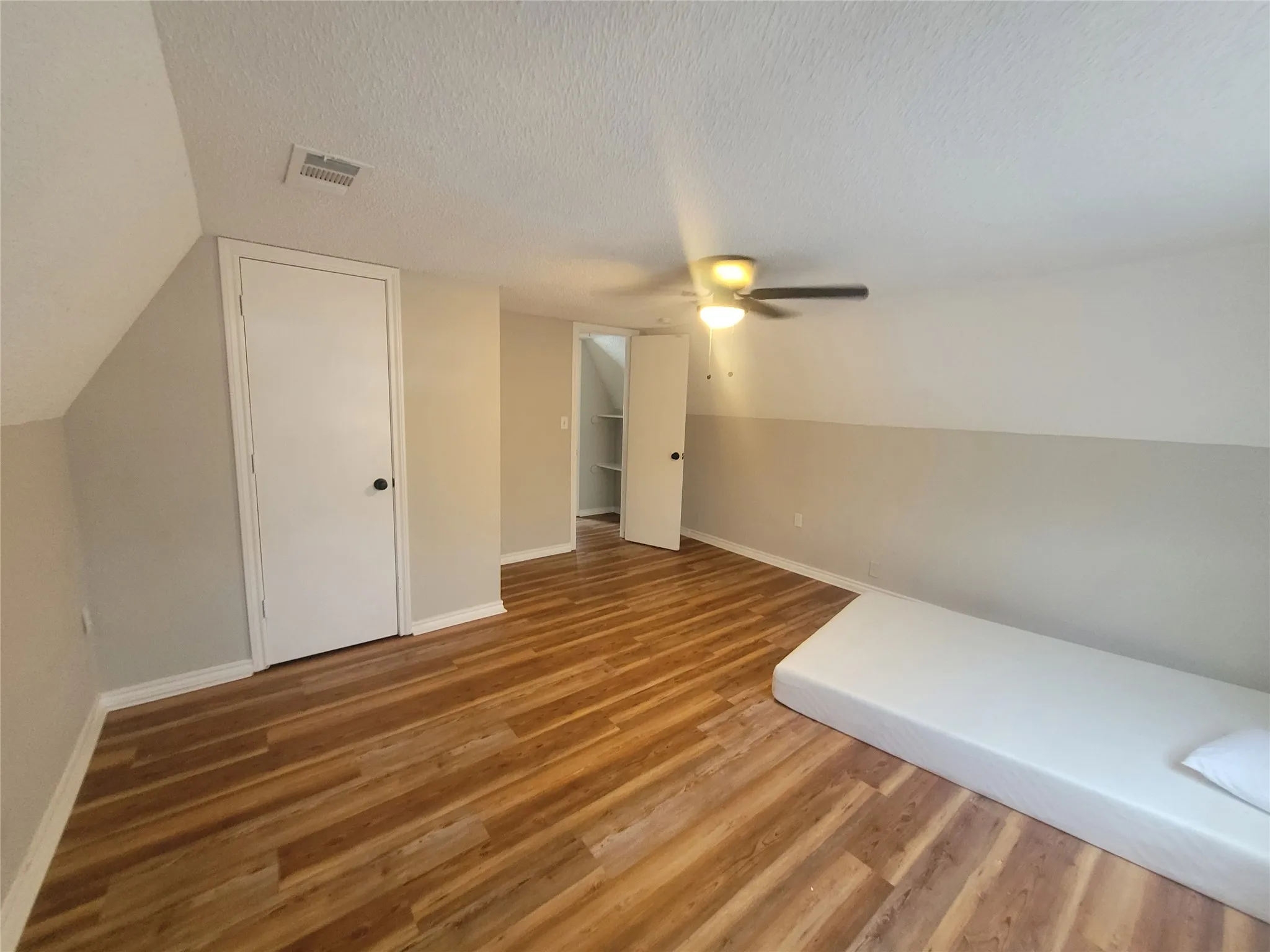 Ceiling fan and beautiful wood floor in upstairs bedroom.