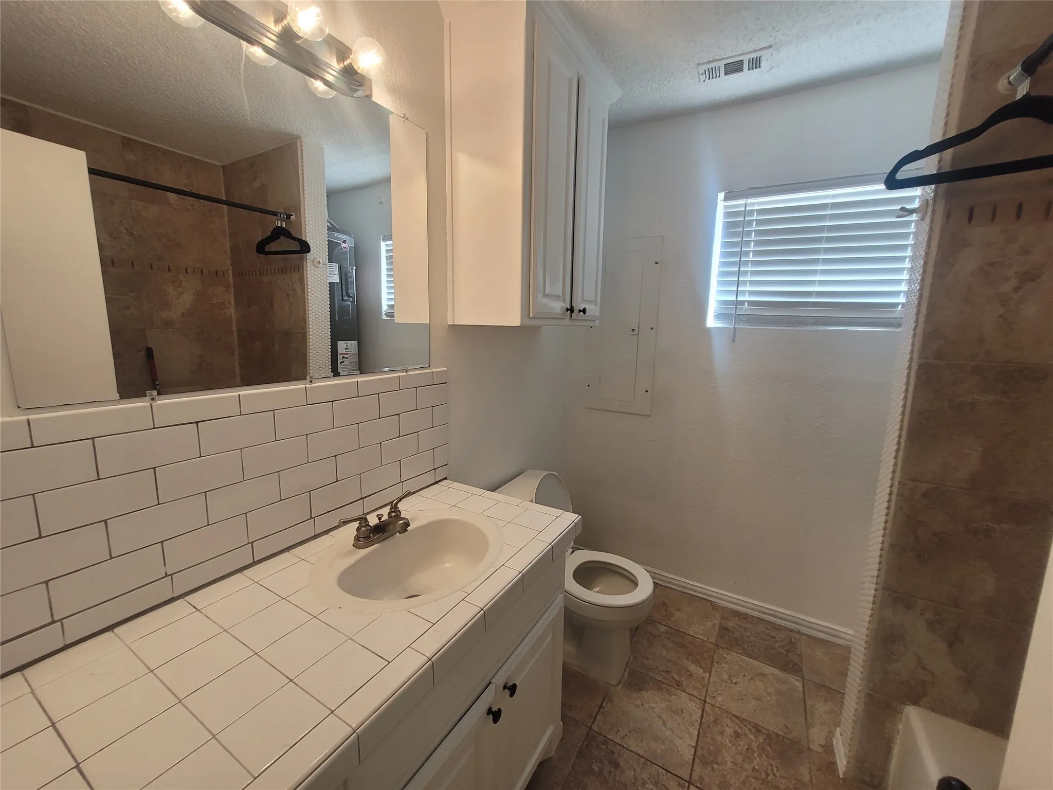 Full bath with tub and shower combination.