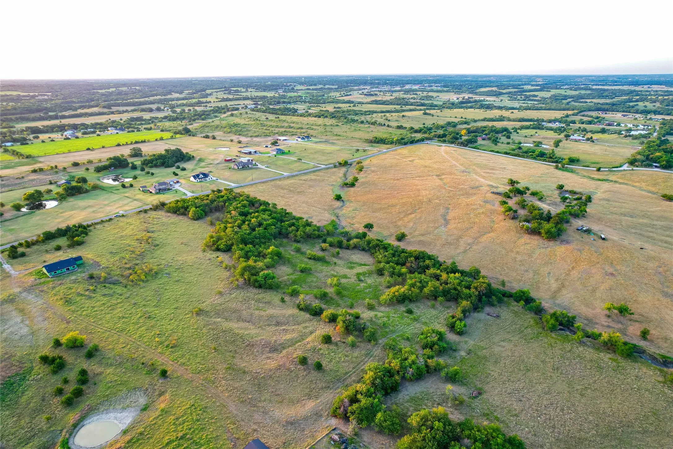 Expansive acreage featuring natural landscaping and scattered trees