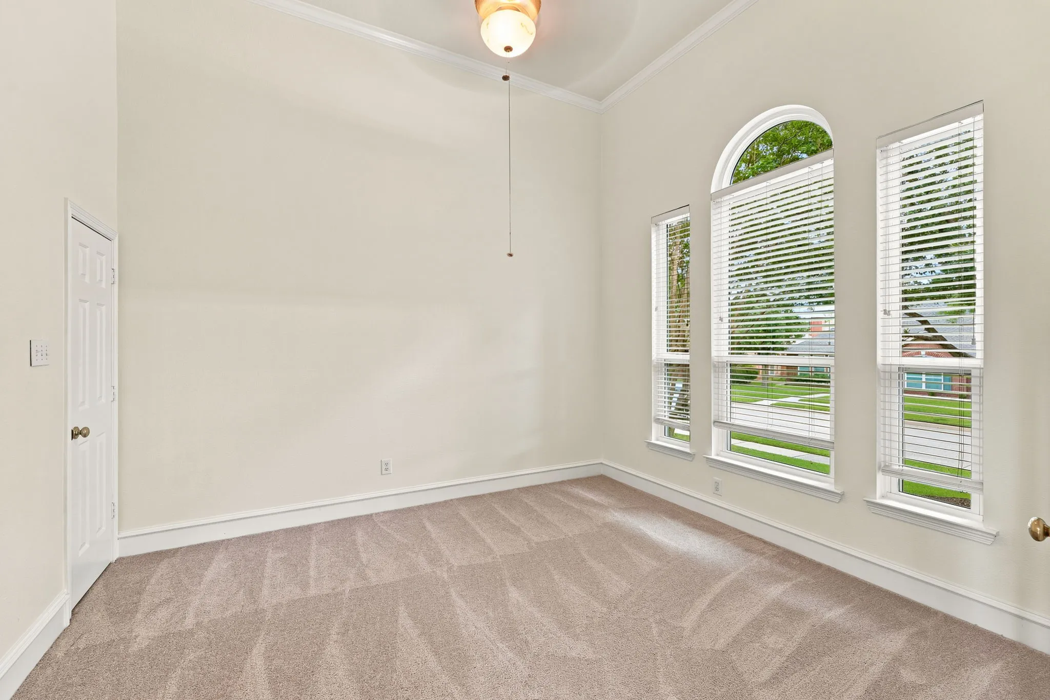 Spacious 4th bedroom or office, featuring vaulted ceilings, neutral-toned carpeting, french doors and a six-panel interior closet door or use for office storage.