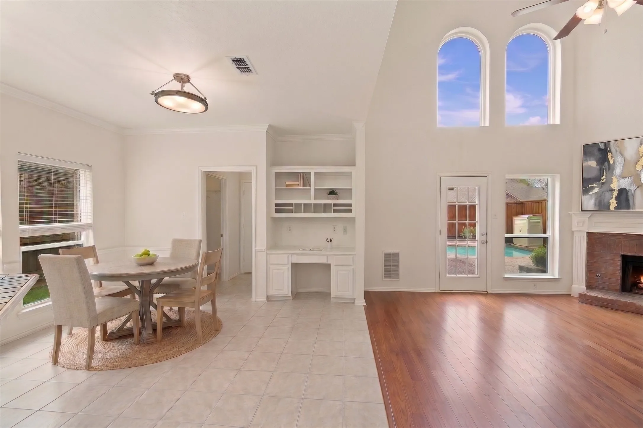 AI generated staging furniture - Hardwood flooring, tiled flooring, built-in cabinetry, and a fireplace with a stone surround