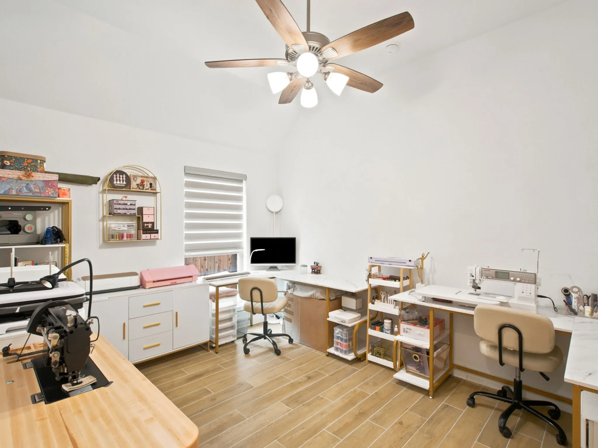 Vaulted ceiling with a ceiling fan, window with horizontal blinds, and wood-finish flooring