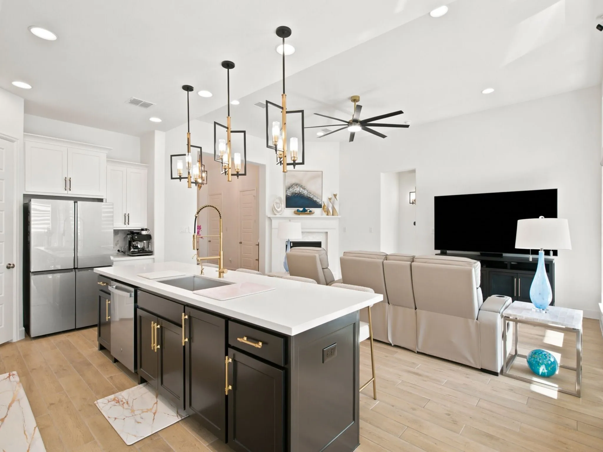 Open-concept living space with wood-finish flooring, recessed lighting, and a modern ceiling fan