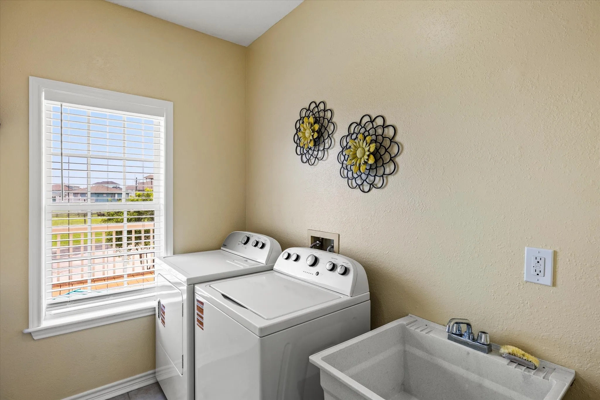 Laundry room with sink and drying space. Starter pods and dryer sheets provided