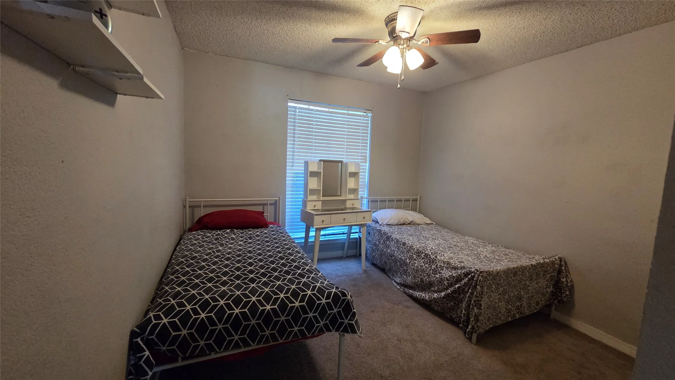 Carpeted flooring, window with blinds, ceiling fan with light fixture, neutral wall color