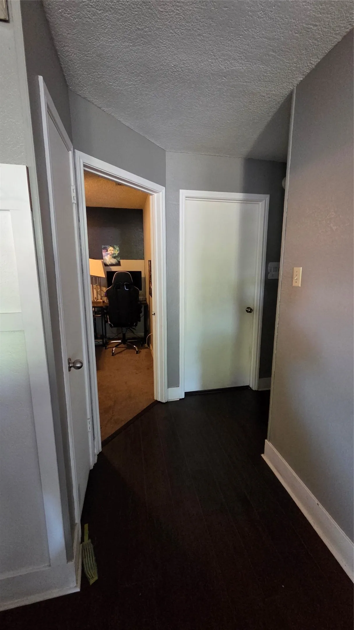 Dark wood-finish flooring with white trim