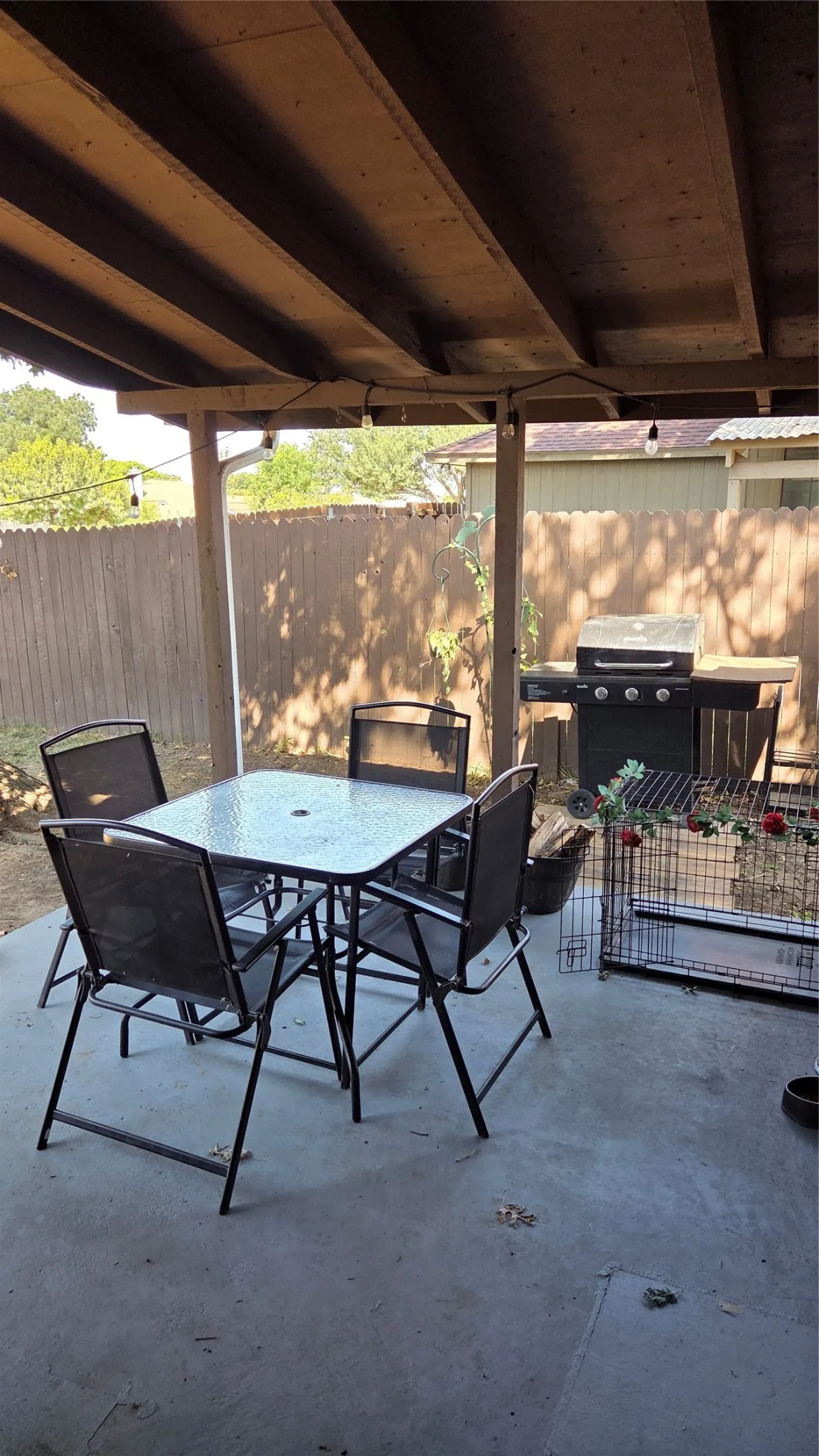 Covered concrete patio with exposed wood beam ceiling