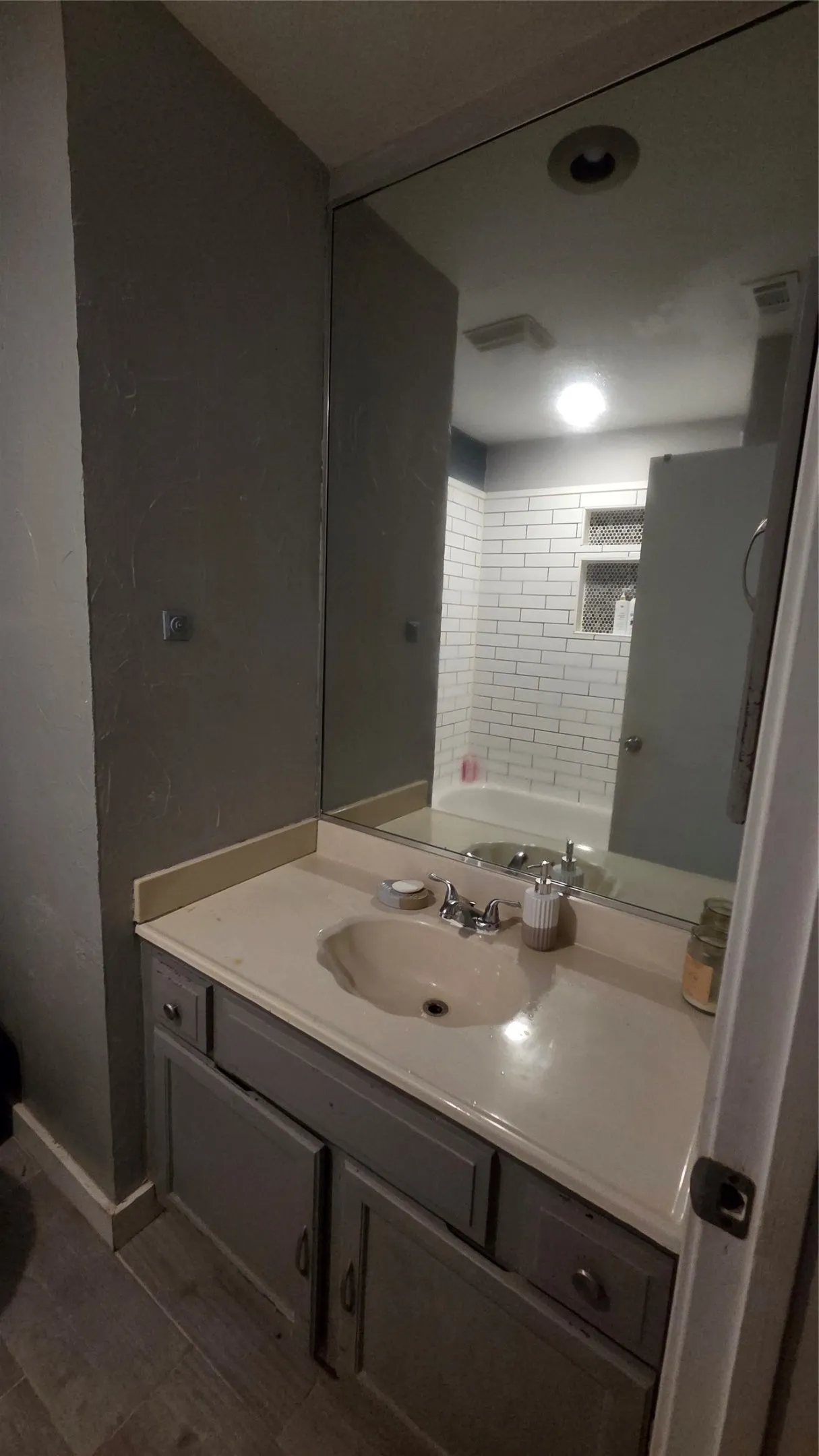 Integrated vanity with a single basin sink and dedicated storage