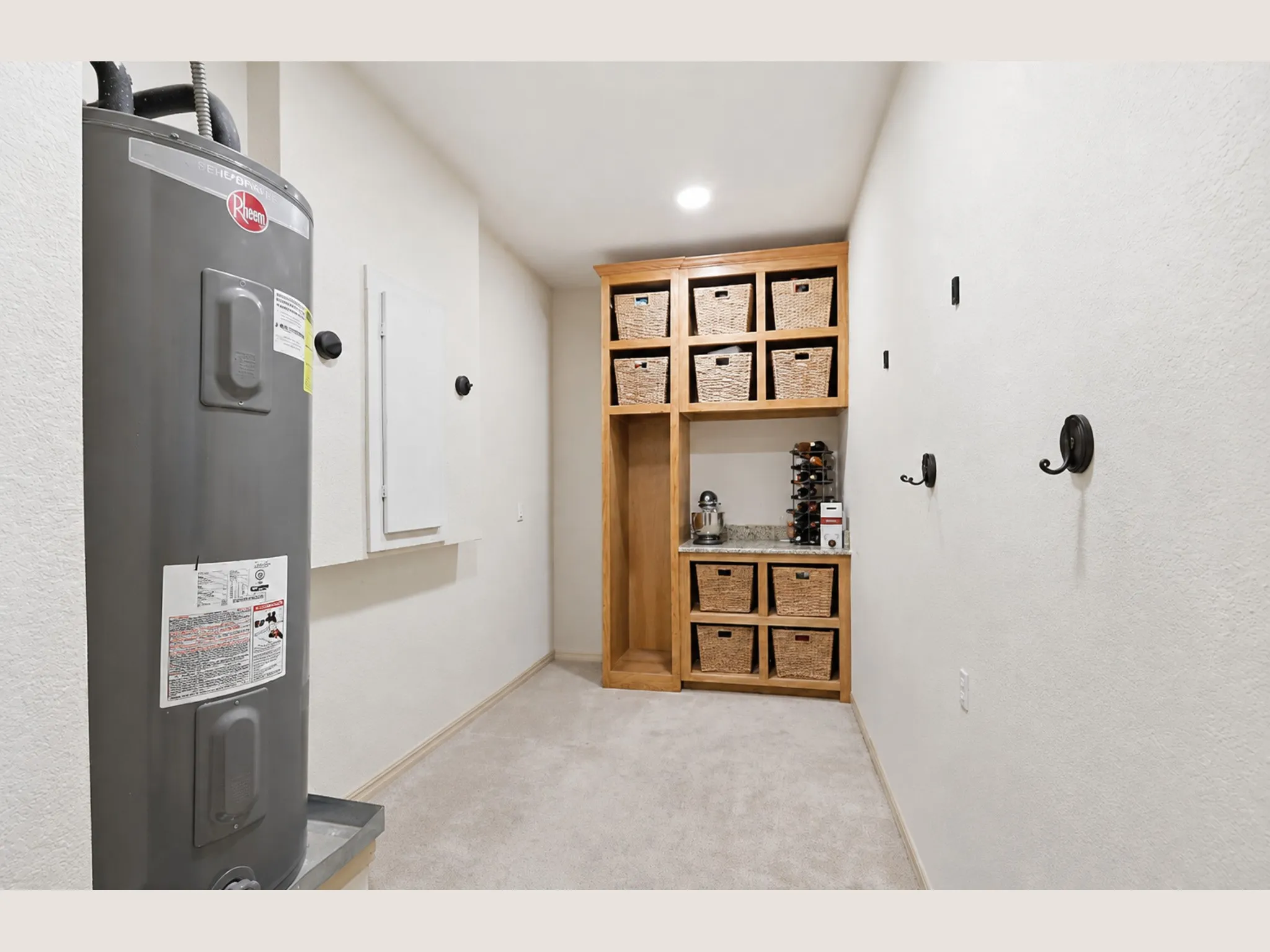 Built-in custom cabinetry with shelving, recessed lighting, and a neutral carpeted floor