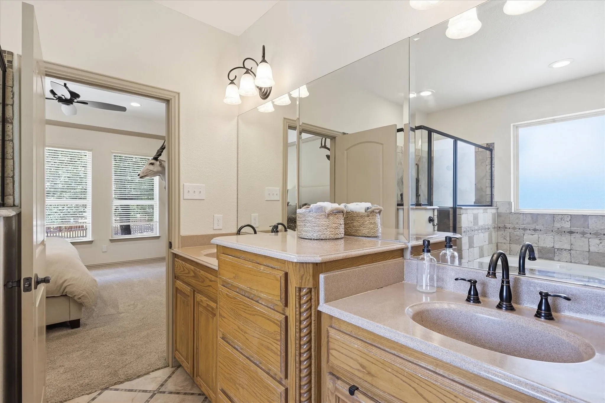 Dual vanity with undermount sinks, bronze-finish fixtures, and light-tone countertops