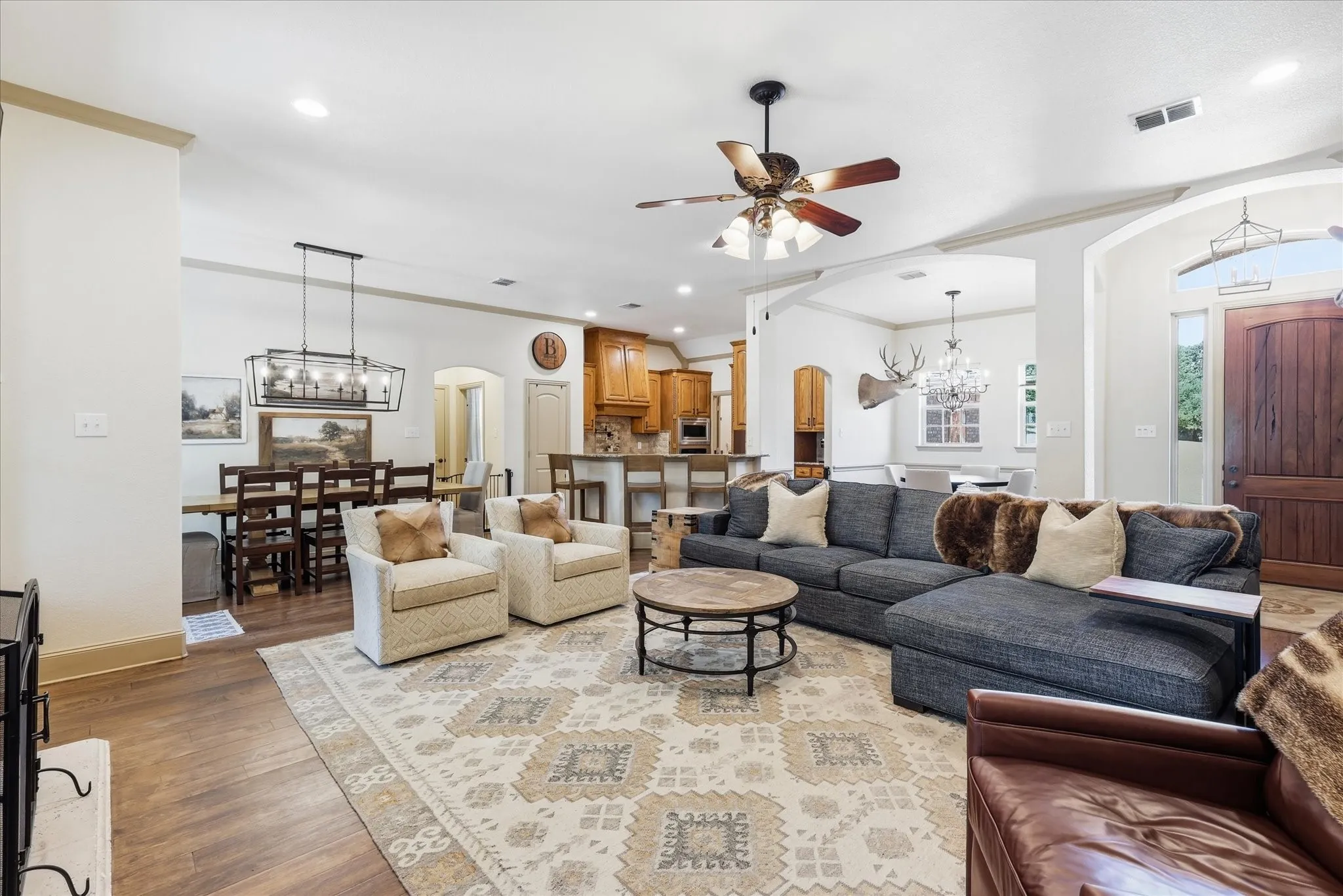 Wood-finish flooring throughout, with a recessed ceiling and ceiling fan