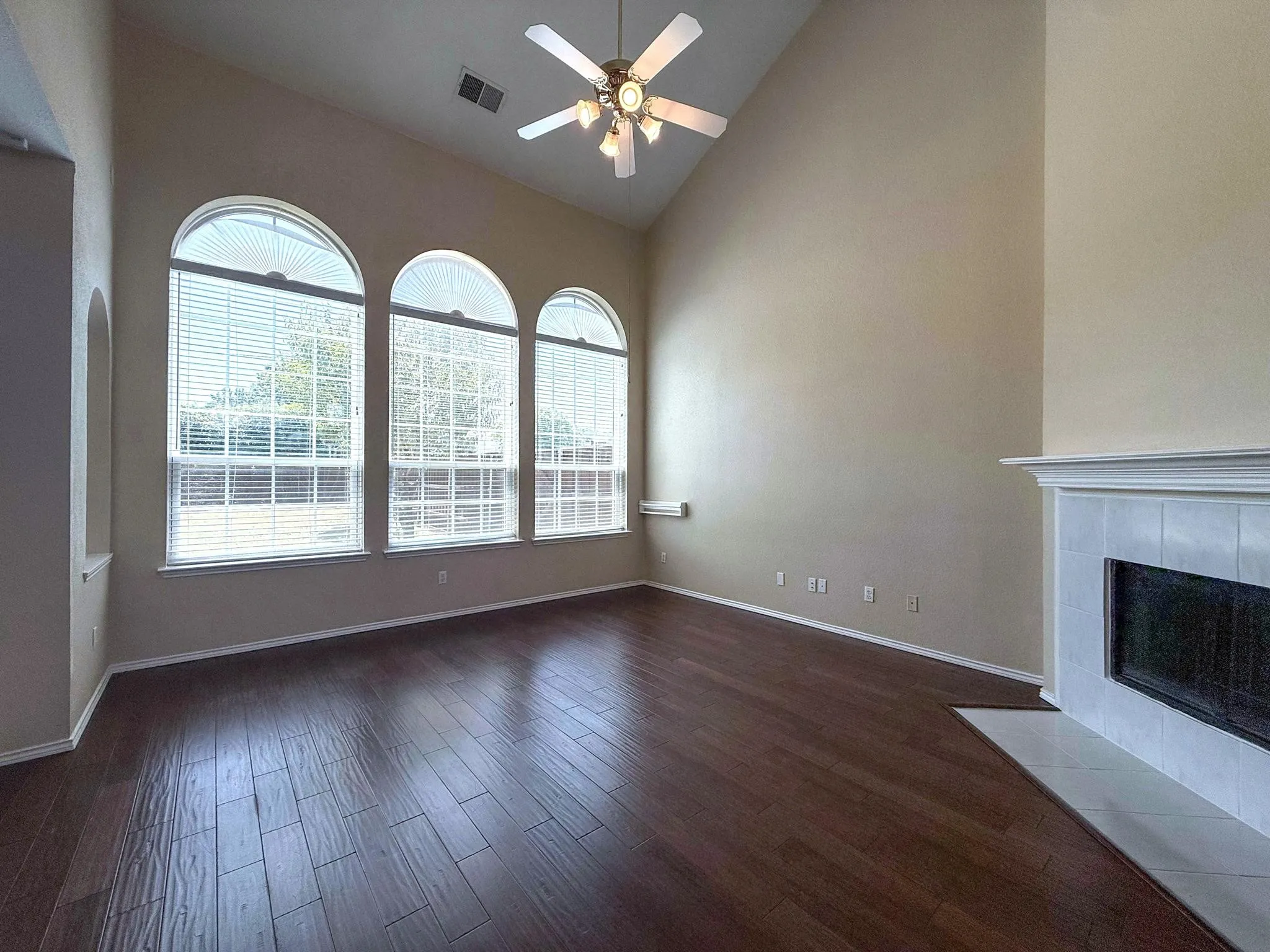 Family room with beautiful fireplace and wood floors.